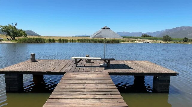 A pier overlooking a small lake on a farm in Paarl district of the Western Cape, South Africa.
