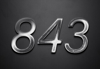 Chrome metal 3D number design of 843 on grey background.