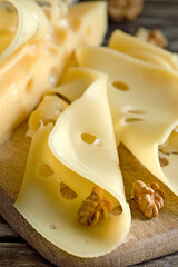 Still life with cheese, milk, walnut and rustic wooden board