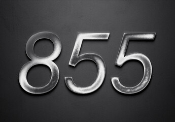 Chrome metal 3D number design of 855 on grey background.