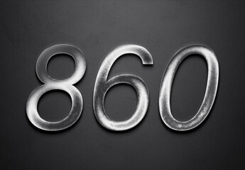 Chrome metal 3D number design of 860 on grey background.