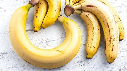 A minimalist arrangement of bananas in a crescent shape, placed on a seamless white surface to create a clean and striking image
