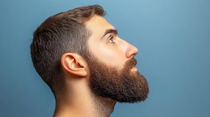 Fototapeta premium Profile view of a man with a full beard