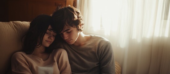 Fototapeta premium Saint Valentine. An intimate moment: young couple holding hands in prayer, bathed in warm sunlight.