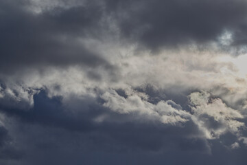 Dense gray-white clouds thicken, blocking the sunlight.