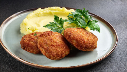 kiev cutlets with a crispy crust and creamy mashed potatoes garnished with fresh herbs