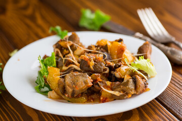 vegetable stew with eggplants, on a wooden table