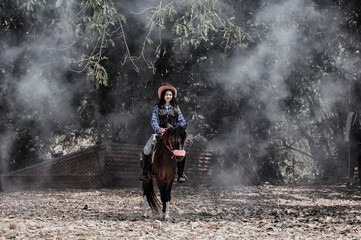 Obraz premium woman riding a horse in farm.