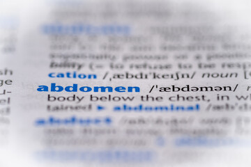 Abdomen word in a dictionary. Selective focus, close up.