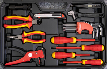 An electrician's tool kit, a suitcase with a variety of tools.