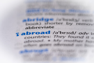 Abroad word in a dictionary. Selective focus, close up.