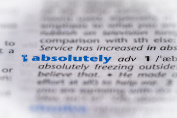 Absolutely word in a dictionary. Selective focus, close up.