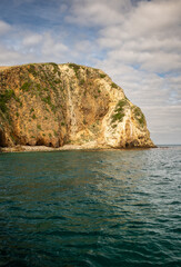 Fototapeta premium Two Hikers Stand On The Cliffs Above Santa Cruz Island