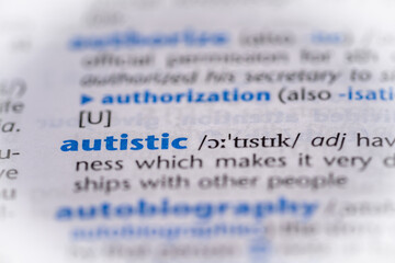 Autistic word in a dictionary. Selective focus, close up.