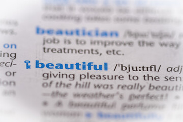 Beautiful word in a dictionary. Selective focus, close up.