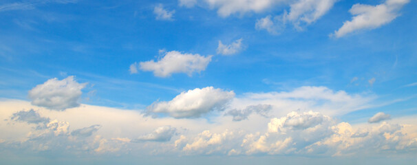 Blue sky and light cumulus clouds.
