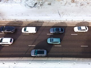  View from the height of the highway clogged with cars. A big long traffic jam of cars moving to...