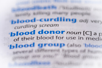 Blood donor word in a dictionary. Selective focus, close up.
