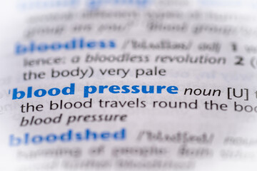 Blood pressure word in a dictionary. Selective focus, close up.