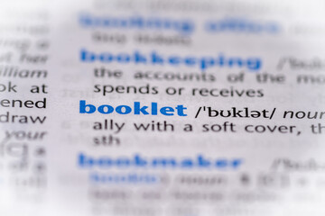 Booklet word in a dictionary. Selective focus, close up.