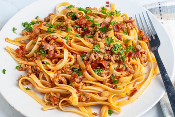 linquine  top with  sausage, bacon and parsley