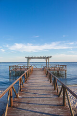 Wooden Pier Overlooking the Ocean on a Sunny Day