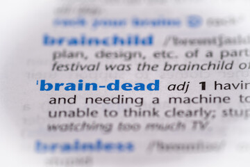 Brain dead word in a dictionary. Selective focus, close up.