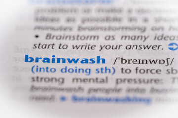Brainwash word in a dictionary. Selective focus, close up.