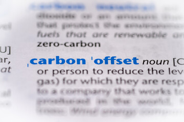 Carbon offset word in a dictionary. Selective focus, close up.