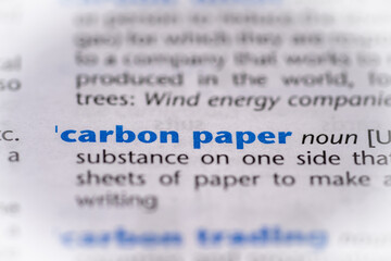 Carbon paper word in a dictionary. Selective focus, close up.