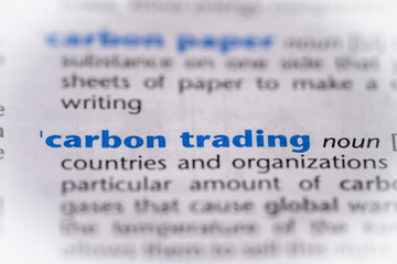 Carbon trading word in a dictionary. Selective focus, close up.