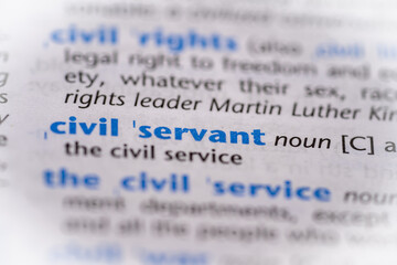 Civil servant word in a dictionary. Selective focus, close up.