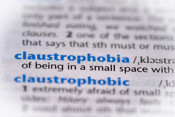 Claustrophobia word in a dictionary. Selective focus, close up.