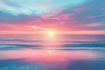 Obraz premium A colorful sunrise over a calm ocean, where the soft light reflects on the water creating a serene and peaceful scene
