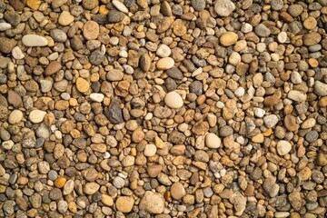 Pebbled beach background with soft focus creates a serene atmosphere for creative projects