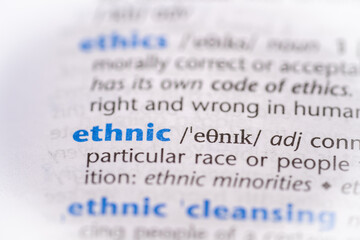 Ethnic word in a dictionary. Selective focus, close up.
