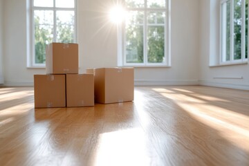 Moving boxes arranged in an empty room with bright sunlight streaming through large windows during the day