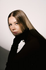 Portrait of a woman in a studio with professional lighting in a smart dress with gloves