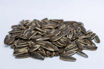 Striped black sunflower seeds on white background, texture, background