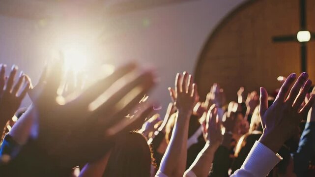 hands of a crowd of people at a Christian meeting during the glorification praise of God against the background of the cross