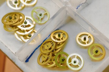 Gears and cogwheels nestled in a workshop brimming with creativity and craftsmanship during a sunny...