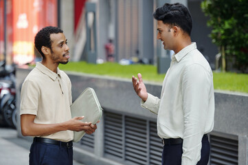 Colleagues talking to each other during their meeting on the street