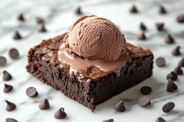 Delicious chocolate brownie with melting chocolate ice cream scoop and chocolate chips on marble