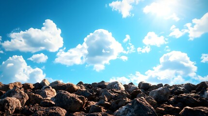 Obraz premium Scenic View of Rocks Under Bright Blue Sky and Fluffy Clouds