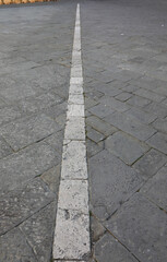 Fototapeta premium white line on the town square that separated the burial place of the church from that of the administration of the nearby hospital creating a shared cemetery in SIENA in ITALY