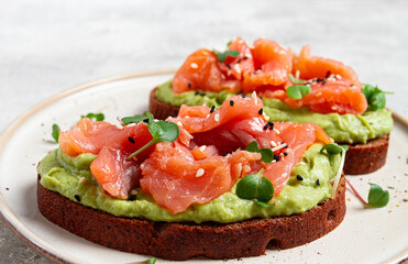 breakfast, Sandwiches with smoked salmon and avocado, on dark rye bread, with microgreens, on a marble table, homemade, no people,