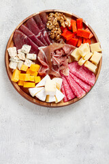 assortment of cheese meat cuts, on a plate, top view, no people,