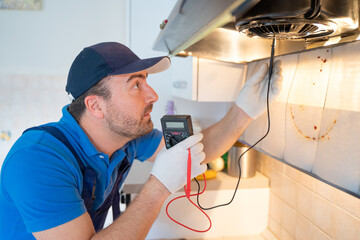 One repairman cleaning a kitchen hood air filter
