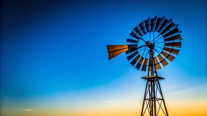 Minimalist Old Windmill Silhouette Against Vibrant Blue Sky - Stock Photo