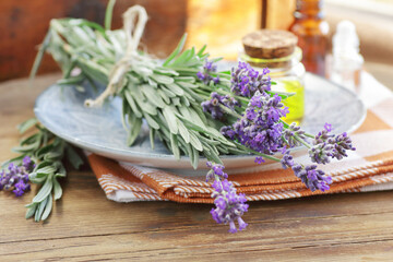 Lavender bouquet with oils or extracts  on wooden background with fresh flowers, copy space, natural medicine,  natural hair and skin treatment, aromatherapy concept